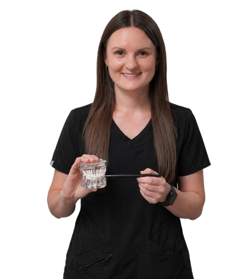 Smiling female dentist holding dental model